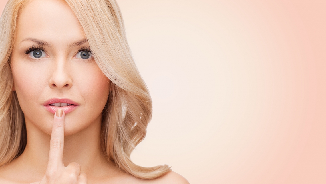 health people and beauty concept beautiful young woman touching her lips over pink background16 9