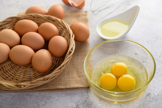 organic eggs and oil preparing cooking meal