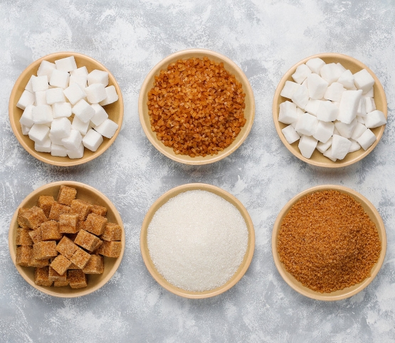 various types of sugar brown sugar and white on concrete top view